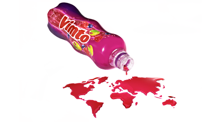 Vimto bottle pouring out in shape of world, conceptual photography